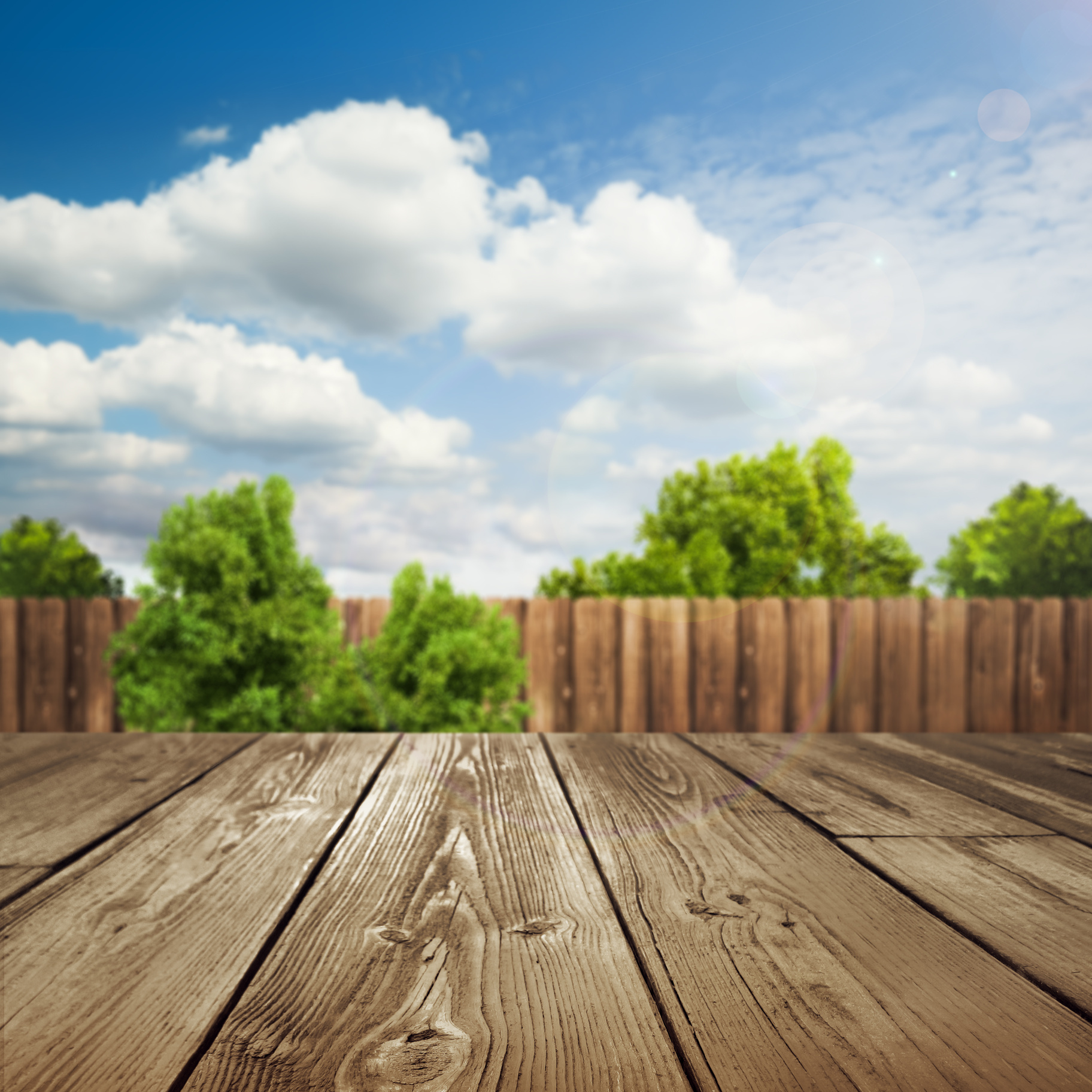 wooden table top with blurred outdoor backyard background